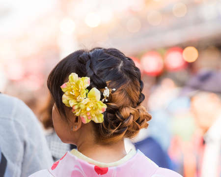 Hairstyle geisha with fresh flowers, Tokyo, Japan. Close-up. Back viewの写真素材
