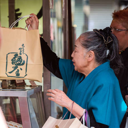 TOKYO, JAPAN - OCTOBER 31, 2017: An elderly woman in the store. Close-upのeditorial素材