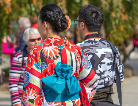 TOKYO, JAPAN - OCTOBER 31, 2017: Girl in a red kimono on a city street. Close-up. Back viewのeditorial素材