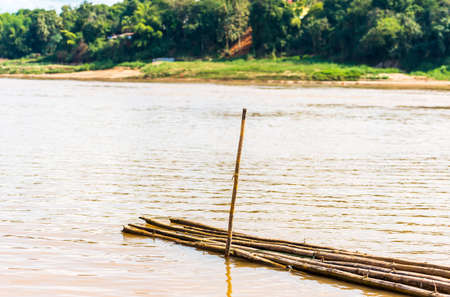 Bamboo sticks by the river Nam Khan in Luang Prabang, Laos. Copy space for textの写真素材