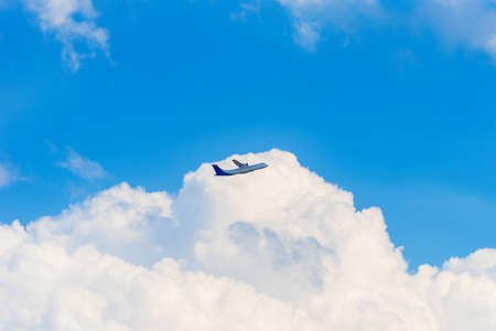 The plane in the sky against a background of white clouds, Luang Prabang, Laos. Copy space for textの写真素材