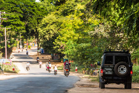 BAGAN, MYANMAR - DECEMBER 1, 2016: City landscape. Transport on the road. Copy space for textのeditorial素材