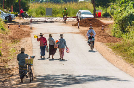 BAGAN, MYANMAR - DECEMBER 1, 2016: People walk along the road. Copy space for textのeditorial素材