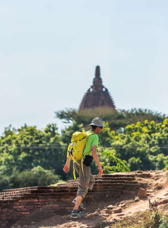 BAGAN, MYANMAR - DECEMBER 1, 2016: The man climbs the mountain. Copy space for text. Verticalのeditorial素材