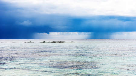 The rain cloud hovered over the sea, Male, Maldives. Copy space for textの写真素材