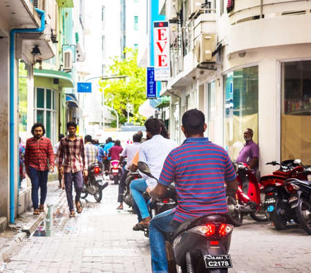 MALE, MALDIVES - NOVEMBER, 27, 2016: View of the city street. People on the city street. Copy space for textのeditorial素材