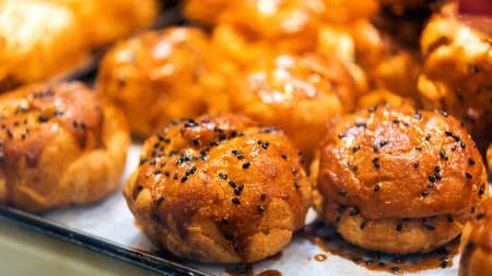 Japanese eclairs sprinkled with sesame seeds, Tokyo, Japan. Close-up
