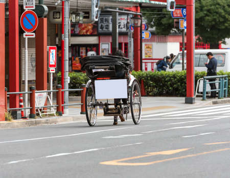 TOKYO, JAPAN - OCTOBER 31, 2017: Rickshaw with a sign for advertising on the streets of the city. Copy space for textのeditorial素材