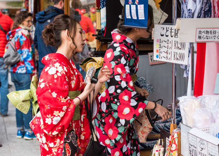 TOKYO, JAPAN - OCTOBER 31, 2017: Two girls in a kimono on a city street. Close-upのeditorial素材