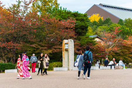 KYOTO, JAPAN - NOVEMBER 7, 2017: Two girls in a kimono on a city street. Copy space for textのeditorial素材