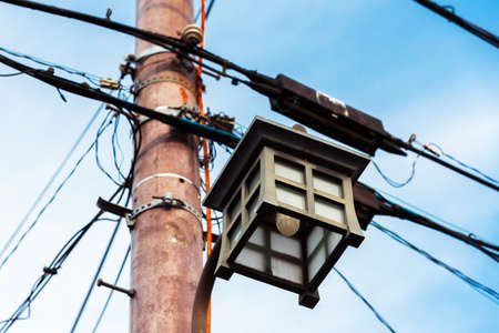 Electric pole with wires against the sky, Kyoto, Japan. Street japanese lantern. Close-upの写真素材