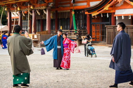 KYOTO, JAPAN - NOVEMBER 7, 2017: A loving couple in a kimono in a town square. Copy space for text