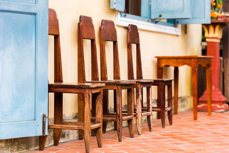 Wooden chairs in a row, Luang Prabang, Laos. Copy space for textの写真素材