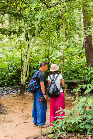 LUANG PRABANG, LAOS - JANUARY 11, 2017: Couple in the forest, Luang Prabang, Laos. Vertical. Copy space for textのeditorial素材