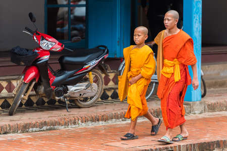 LUANG PRABANG, LAOS - JANUARY 11, 2017: Monks on a city street. Copy space for text