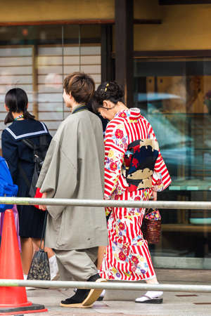 KYOTO, JAPAN - NOVEMBER 7, 2017: Couple in a kimono on a city street. Vertical. Copy space for textのeditorial素材