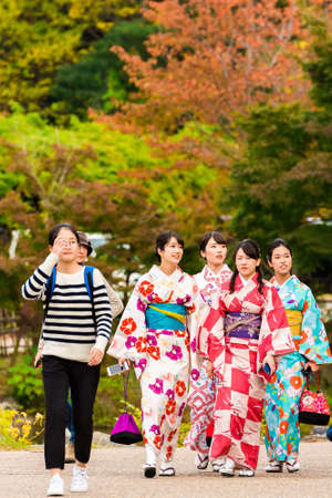 KYOTO, JAPAN - NOVEMBER 7, 2017: Group of girls in a kimono on a city street. Copy space for text. Verticalのeditorial素材