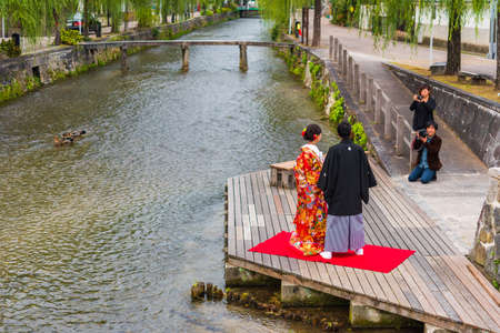 KYOTO, JAPAN - NOVEMBER 7, 2017: Couple in a kimono on the river bank. Copy space for textのeditorial素材