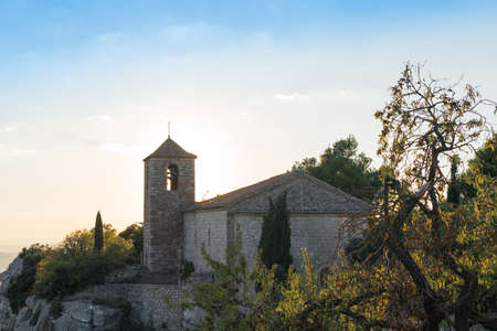 View of the Romanesque church of Santa Maria de Siurana at sunset in Siurana de Prades, Tarragona, Spain. Copy space for textの写真素材