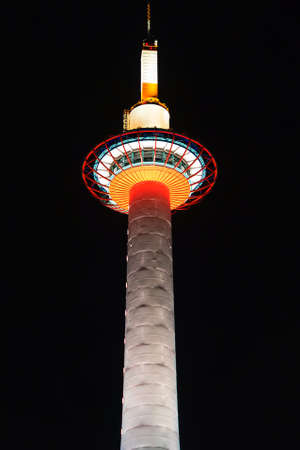 Kyoto Tower illuminated at night, Kyoto, Japan. Copy space for text. Vertical