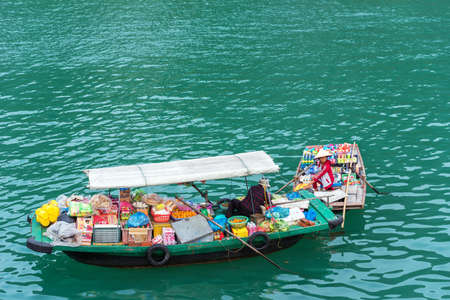 HALONG, VIETNAM - DECEMBER 16, 2016: Shop with products on the water in the bay. Copy space for textのeditorial素材