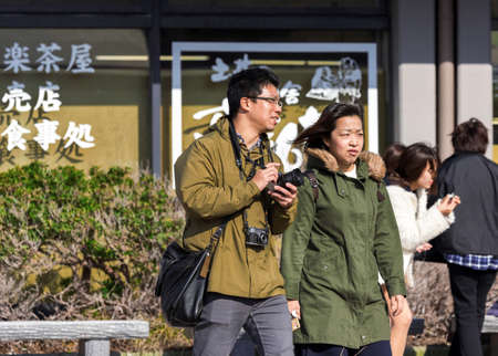 HAKONE, JAPAN - NOVEMBER 5, 2017: Japanese couple on a city street