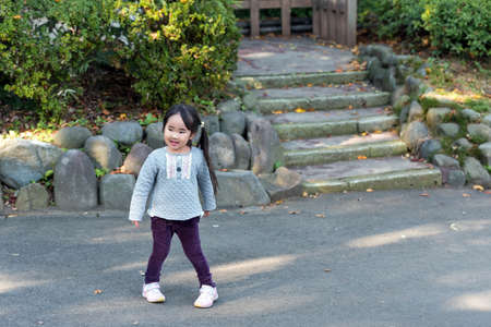 ODAWARA, JAPAN - NOVEMBER, 11, 2017: Japanese girl with two tails in the city park.のeditorial素材