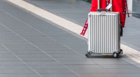 TOKYO, JAPAN - NOVEMBER 7, 2017: Silver suitcase on the airport territory.のeditorial素材