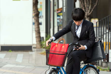 TOKYO, JAPAN - OCTOBER 31, 2017: Boy on a bike on a city street. Copy space for textのeditorial素材