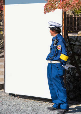 KYOTO, JAPAN - NOVEMBER 7, 2017: Japanese policeman on white banner background. Frame for text. Copy space for textのeditorial素材