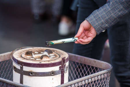 Incense sticks in hand, Tokyo, Japan