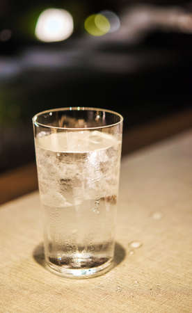 A glass of cold water on a table, Tokyo, Japan. Verticalの写真素材
