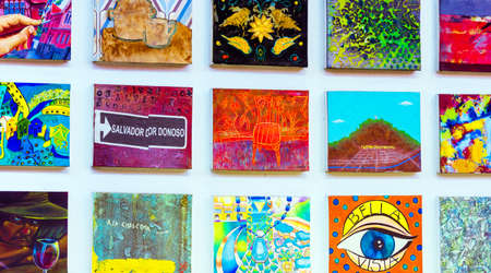 SANTIAGO, CHILE - JANUARY 10, 2018: Paintings hanging on a white wall in a rowのeditorial素材