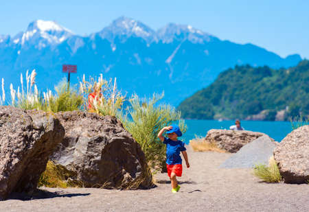 PATAGONIA, CHILE - JANUARY 4, 2018: Girl in a blue hat against the background of mountains, South America. Copy space for textのeditorial素材