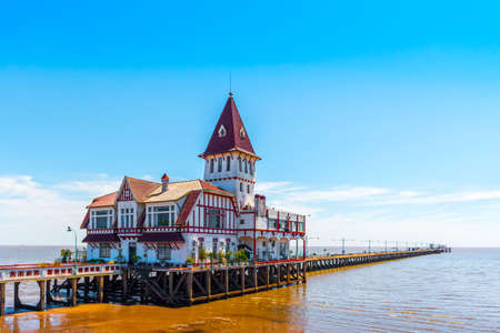 Building and pier at the shore of the Atlantic Ocean, Buenos Aires, Argentina. Copy space for textの写真素材