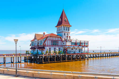 Building and pier at the shore of the Atlantic Ocean, Buenos Aires, Argentina. Copy space for textの写真素材