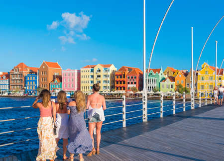 WILLEMSTAD, NETHERLANDS - JANUARY 23, 2018: A group of girls on the bridge. Copy space for textのeditorial素材