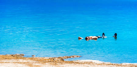 ATACAMA, CHILE - JANUARY 17, 2018: A man swims on his back in Salt Lake. Copy space for textのeditorial素材