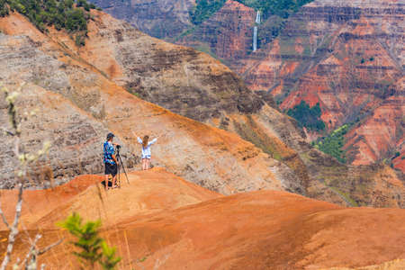KAUAI, HAWAII - FEBRUARY 9, 2018: Amazing Waimea canyon. Couple is photographed on the edge of a cliffのeditorial素材