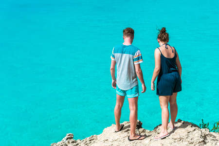 Couple on a cliff on the background of the sea, Curacao, Netherlandsの写真素材