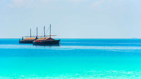 Boats off the coast of the island, Maldives. Copy space for textの写真素材