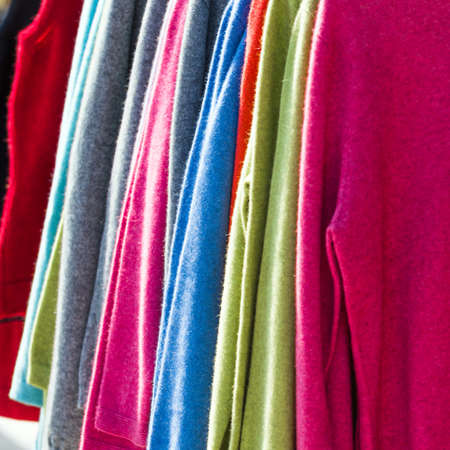 Pullovers hang on a hanger in the store, New Zealand. Close-up