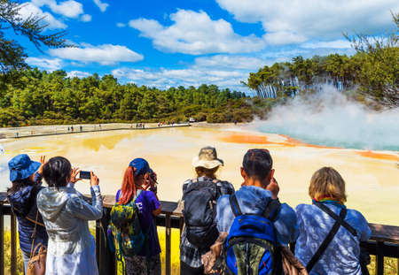 ROTORUA, NEW ZEALAND - OCTOBER 10, 2018: A group of people on the background of geothermal pools in Wai-O-Tapu parkのeditorial素材