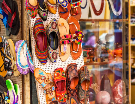 Shoes hanging on the wall in the workshop of the shoe maker, Puttaparthi, Indiaの写真素材