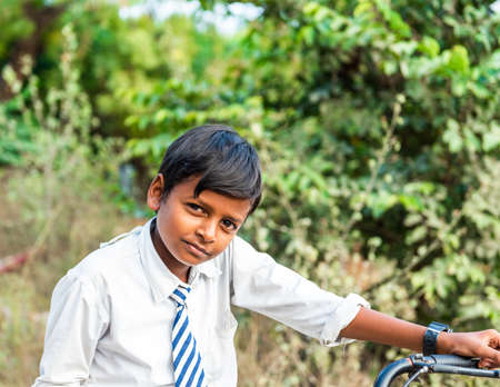 PUTTAPARTHI, INDIA - NOVEMBER 29, 2018: Indian boy in school uniform. With selective focusのeditorial素材