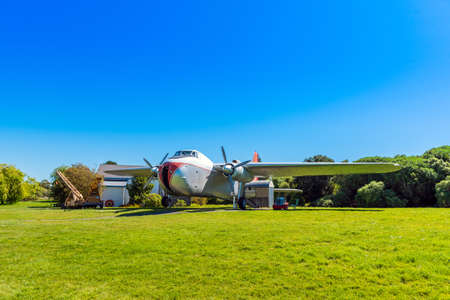 NELSON, NEW ZEALAND - OCTOBER 16, 2018: Retro airplane on a green lawn, Founders Park. Copy space for textのeditorial素材