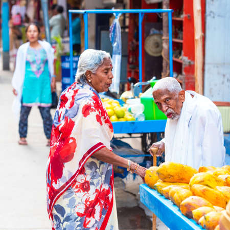 PUTTAPARTHI, INDIA - NOVEMBER 29, 2018: Elderly indian couple at local market. With selective focus