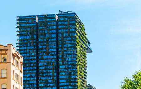 SYDNEY, AUSTRALIA - OCTOBER 27, 2018: Green ecological facade of skyscraper covered in plants