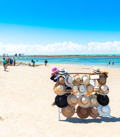 IPOJUCA, BRAZIL - JUNE 18, 2019: Sunhats on the beach of Porto de Galinhas. Copy space for text