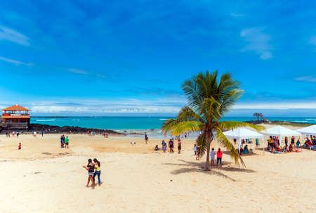 GALAPAGOS ISLAND, ISLA ISABELA - JULY 2, 2019: Group of people on a sandy beach.のeditorial素材